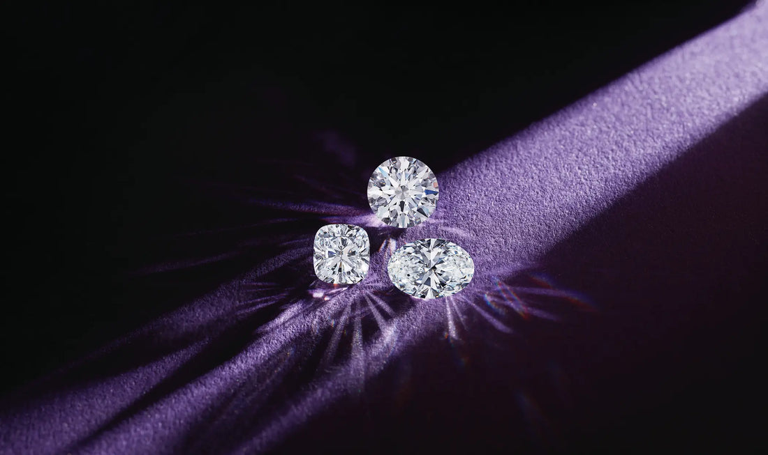 A round, cushion and oval diamond against a deep purple background