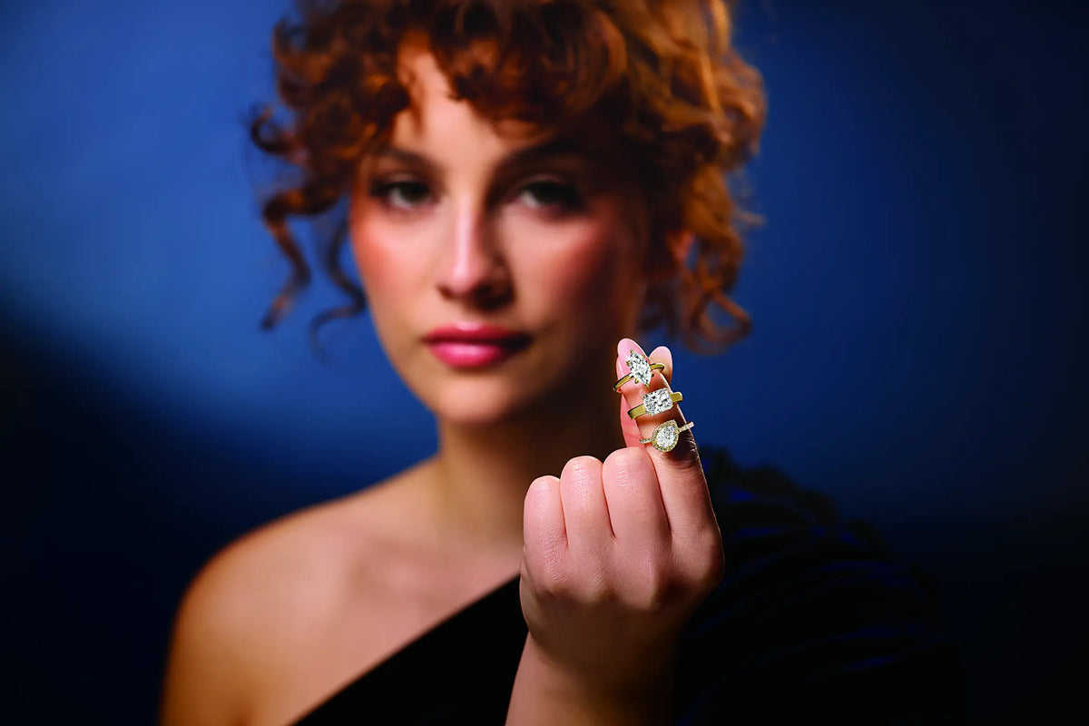 Woman showcasing three diamond engagement rings
