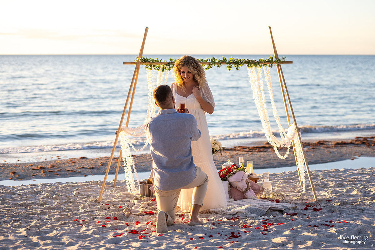 couple getting engaged on the beach