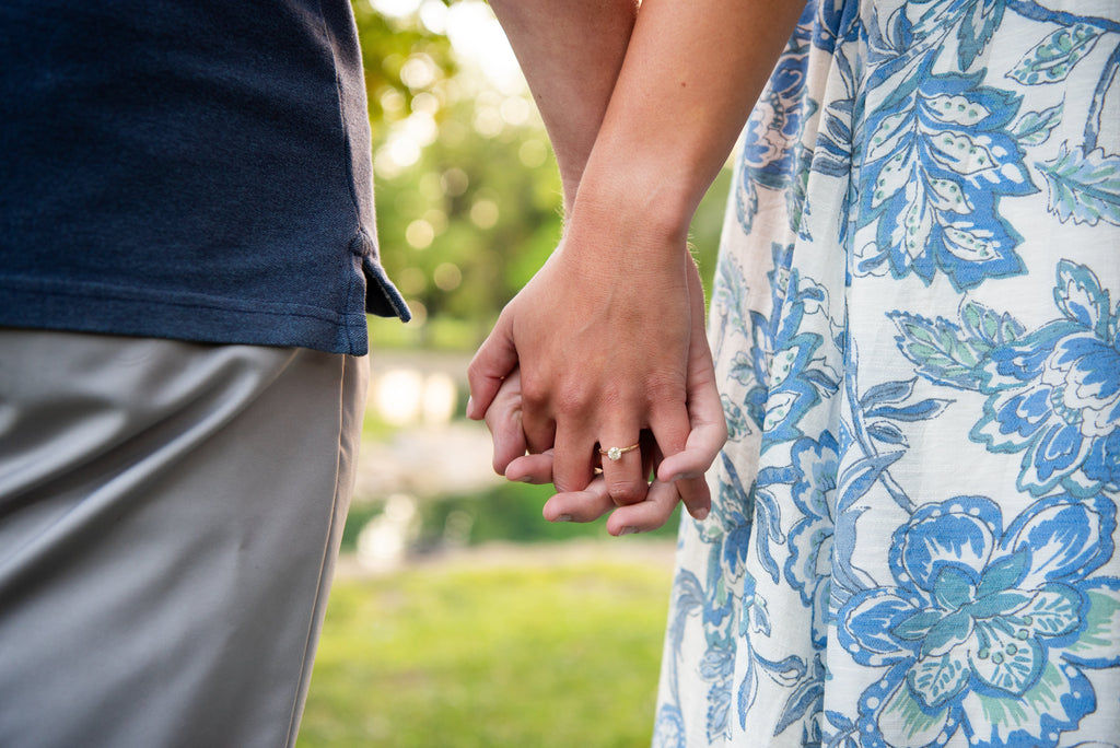 engaged couple holding hands
