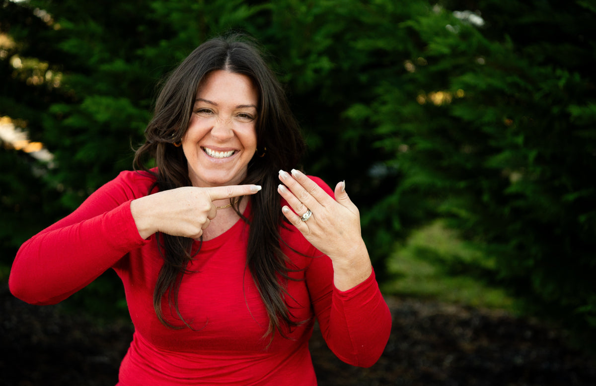 woman pointing to diamond ring on finger