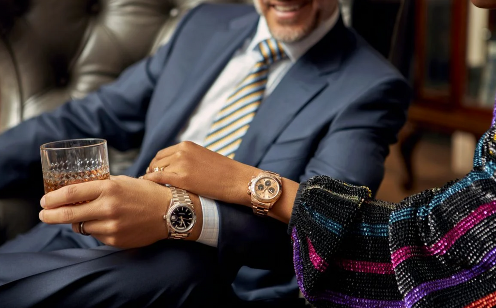 man and woman wearing rolex watches