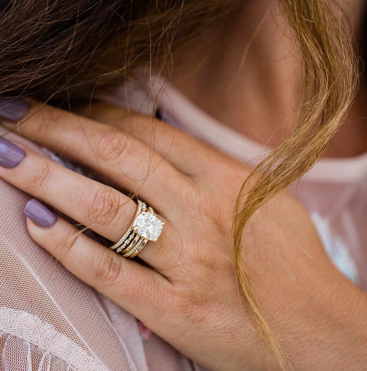 elongated diamond engagement ring on hand