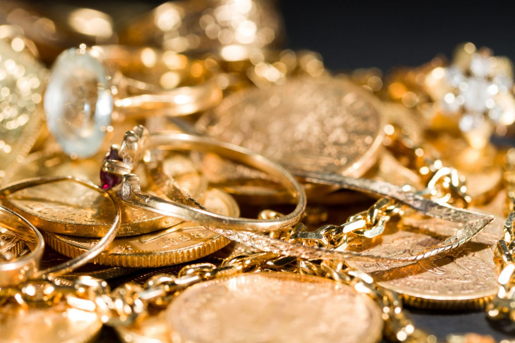 pile of gold chains and coins