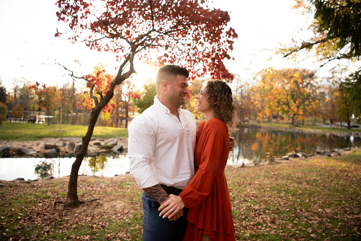 engaged couple with fall leaves