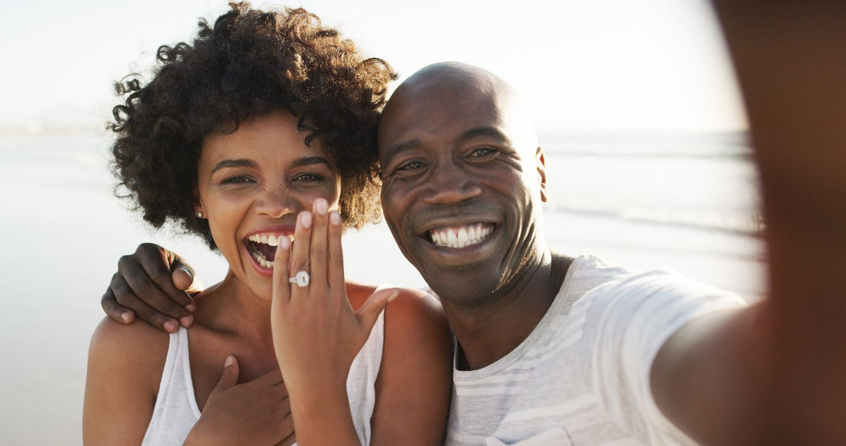 couple smiling with diamond engagement ring