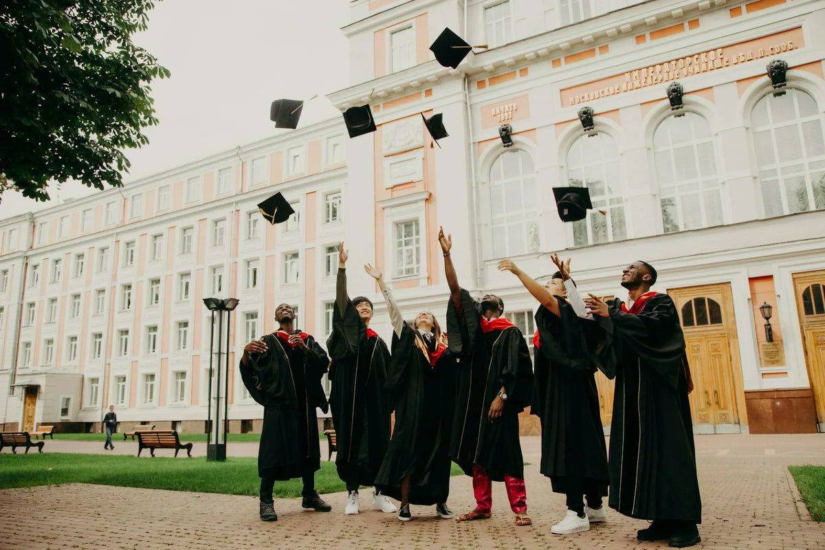 Graduates celebrating outside a school