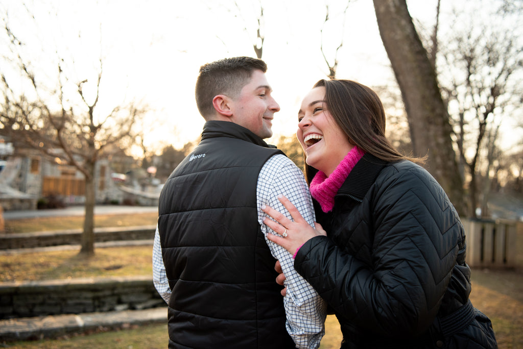 smiling couple with diamond engagement ring