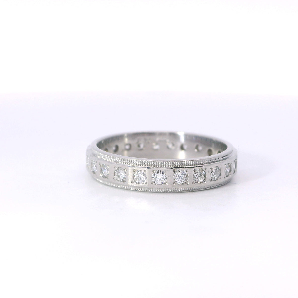 Estate Platinum Beveled Edge Flush Diamond Eternity Band