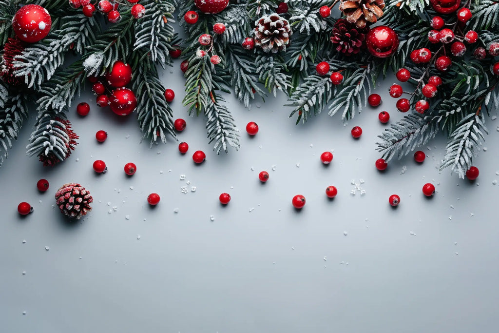 Pine cones, red berries, ornaments and pine leaves covered in snow