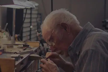 Experienced graduates of the Gemological Institute inspecting jewelry