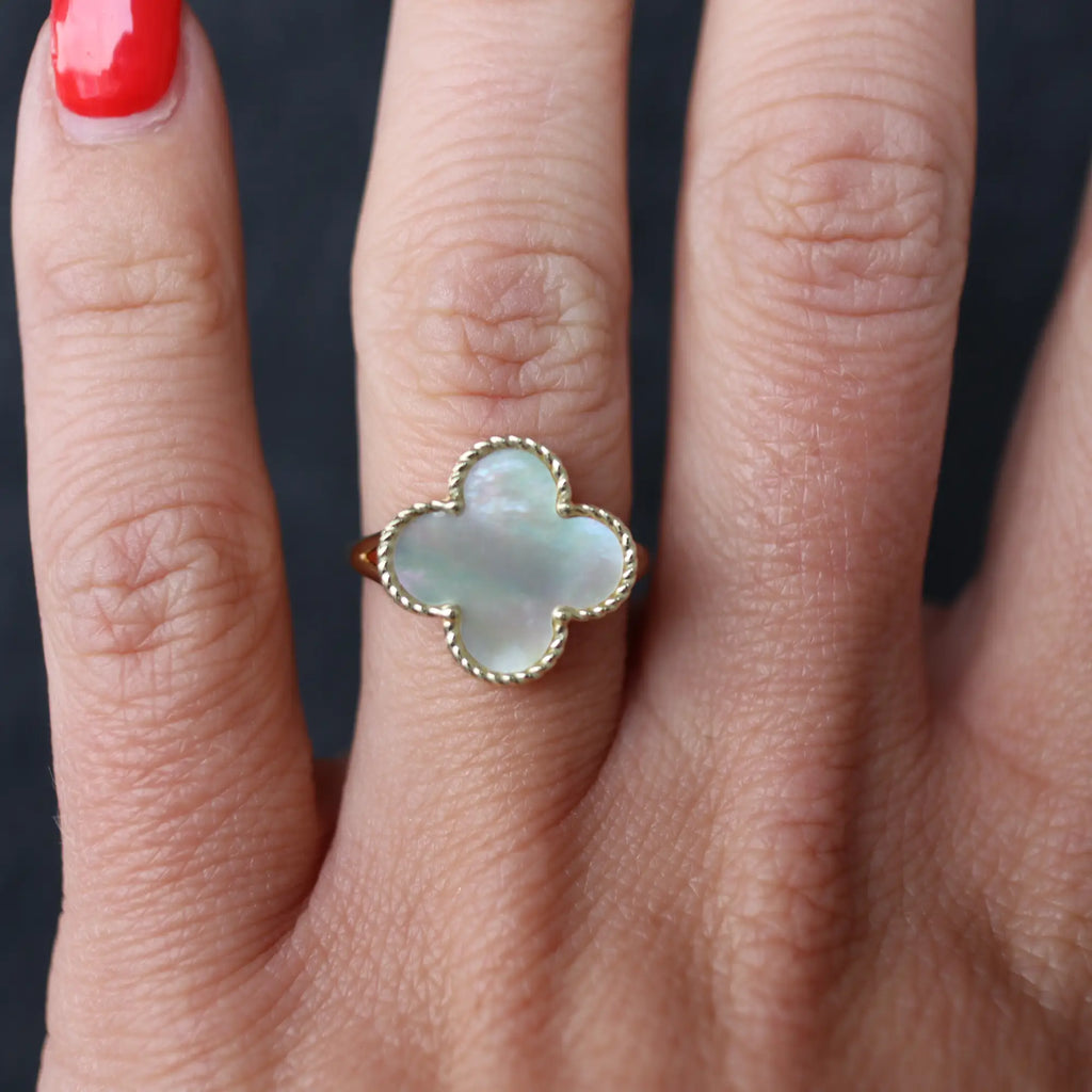 Opal and gold ring on hand