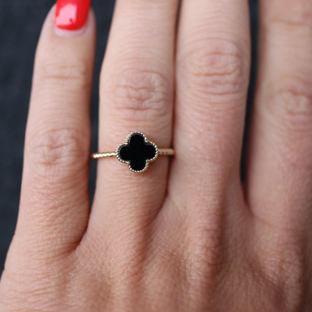 black and gold ring on hand