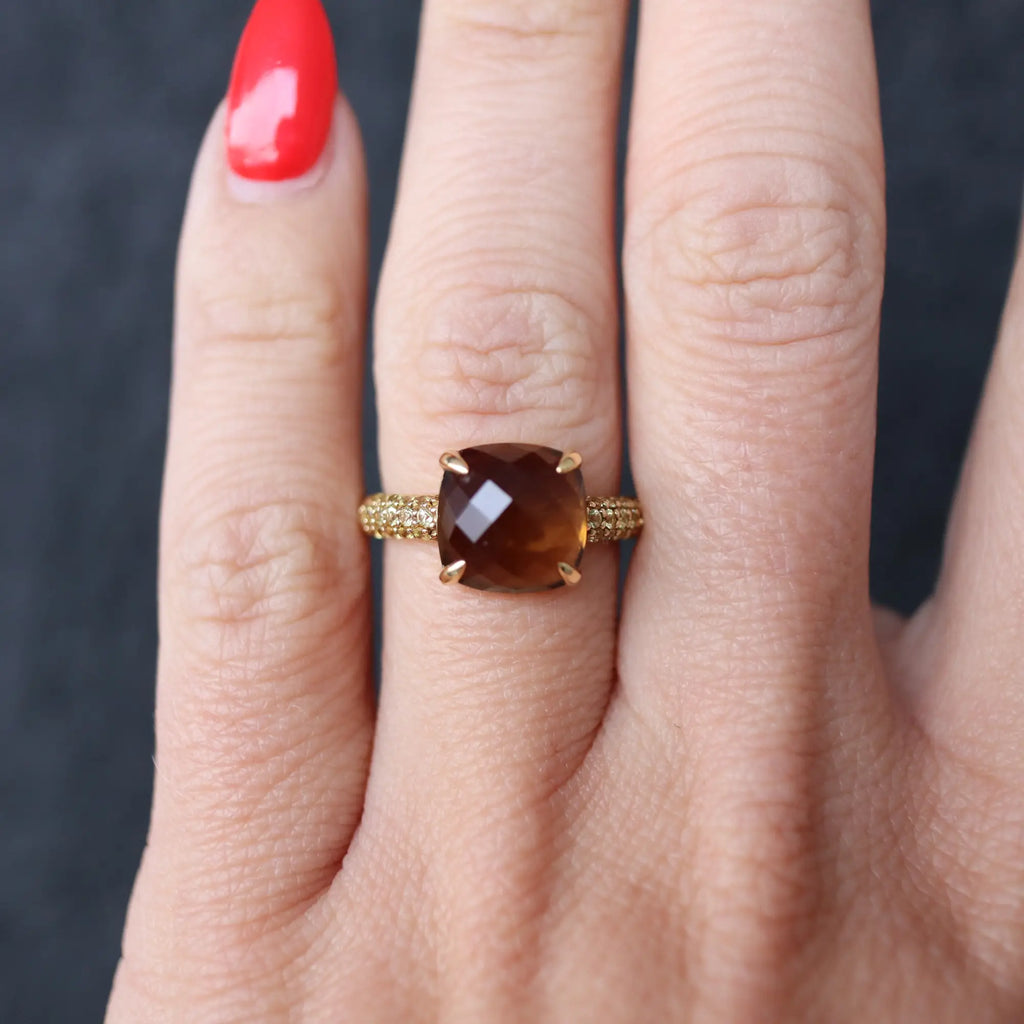 brown and gold ring on hand