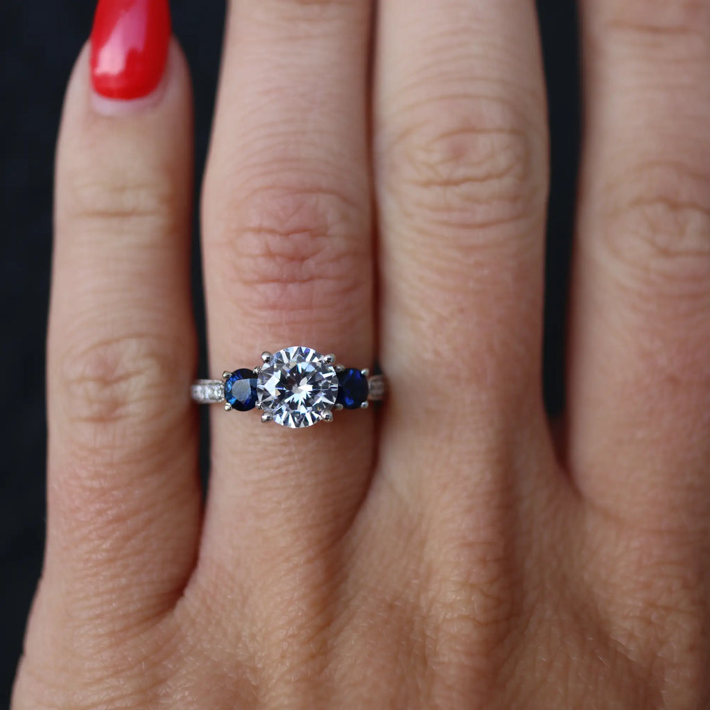 blue and diamond engagement ring on hand