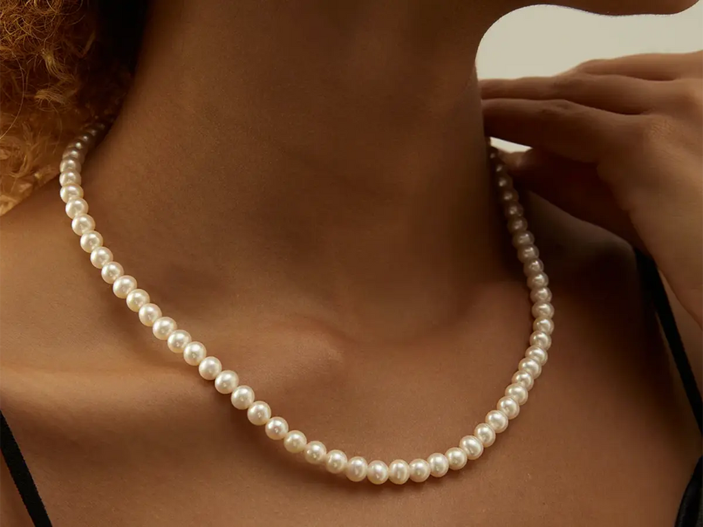 Woman wearing strand of white pearls