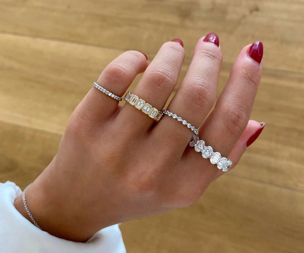Various wedding band styles on woman's fingers